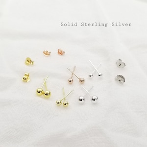 May include: A set of six pairs of sterling silver stud earrings. Each pair features a small, round ball. The earrings are displayed on a white surface. Solid Sterling Silver.