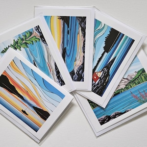 May include: A collection of five rectangular greeting cards featuring colorful landscape illustrations. The designs include stylized depictions of sunsets, mountains, lakes, and forests with bold lines and vibrant blue, orange, and green color palettes.