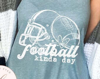 May include: A light blue tank top with a white graphic of a football helmet and football with the text "football kinda day".