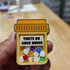 Cute pill bottle shaker badge reel, that’s on back order , pharmacist badge holder, interactive ID holder. Shaker badge clip