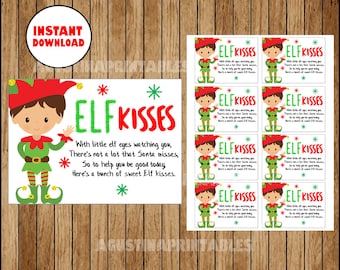 以下が含まれることがあります： 「ELF KISSES」のテキストが入った漫画の妖精のデジタルダウンロード。妖精は赤い帽子と緑色の衣装を着ています。テキストには、妖精の目とサンタについての詩が含まれています。複数の小さなタグも含まれています。
