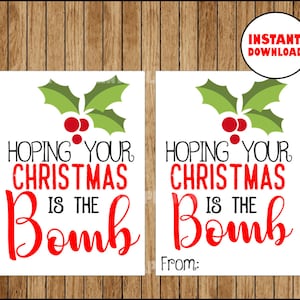 May include: Two white Christmas gift tags with the text "Hoping Your Christmas Is The Bomb" in black and red, topped with a green holly and red berry design. A circular "Instant Download" graphic is in the upper right corner.