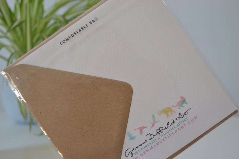 May include: A white card with the text "COMPOSTABLE BAG" printed in black at the top. The bottom of the card features a colorful illustration of animals and birds with the text "Gemma Duffield Art" and "PET PORTRAIT & WILDLIFE ARTIST" in black. The text "GEMMADUFFIELDART.COM" is printed in black below the artist's name.