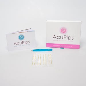 May include: A home kit for ear seed acupuncture. The kit includes a box with the AcuPips logo, a booklet with instructions, a sheet of ear seeds, and tweezers.