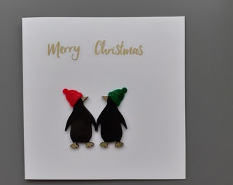 Christmas wooden penguins with bobble hats Merry Christmas card by Sarah Sample Art