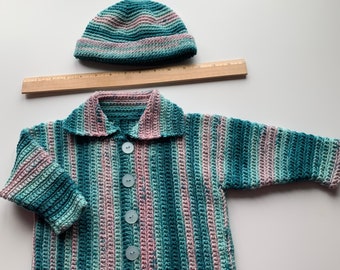 Pretty crocheted baby cardigan sweater and hat set.