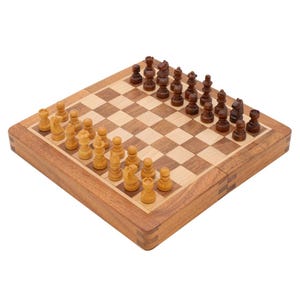 Puede incluir: Un juego de ajedrez de madera con un tablero a cuadros y piezas de ajedrez en dos colores, marrón claro y oscuro. El tablero es cuadrado y las piezas están dispuestas para el inicio de una partida.