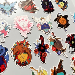 May include: A collection of colorful, die-cut stickers featuring various fantasy-themed designs. The stickers showcase detailed illustrations of angels, dragons, swords, and other symbolic elements, with a mix of vibrant colors and intricate patterns.