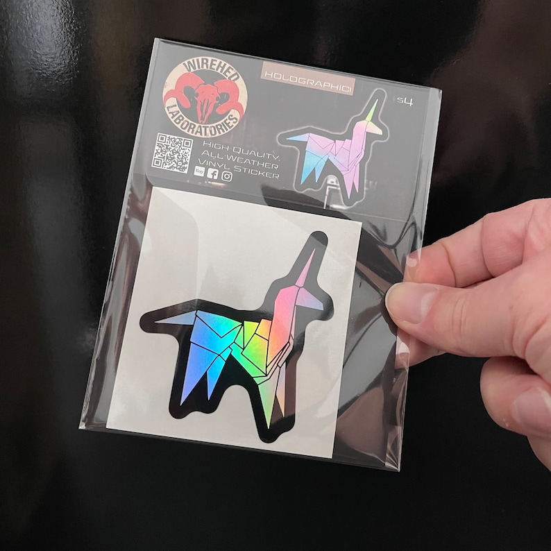 May include: A holographic sticker of a rainbow origami unicorn in a clear plastic bag. The sticker is labeled "HOLOGRAPHIC" and "S4".