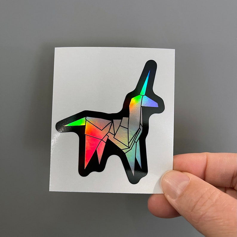May include: A holographic sticker of a black origami unicorn with rainbow iridescent colors.