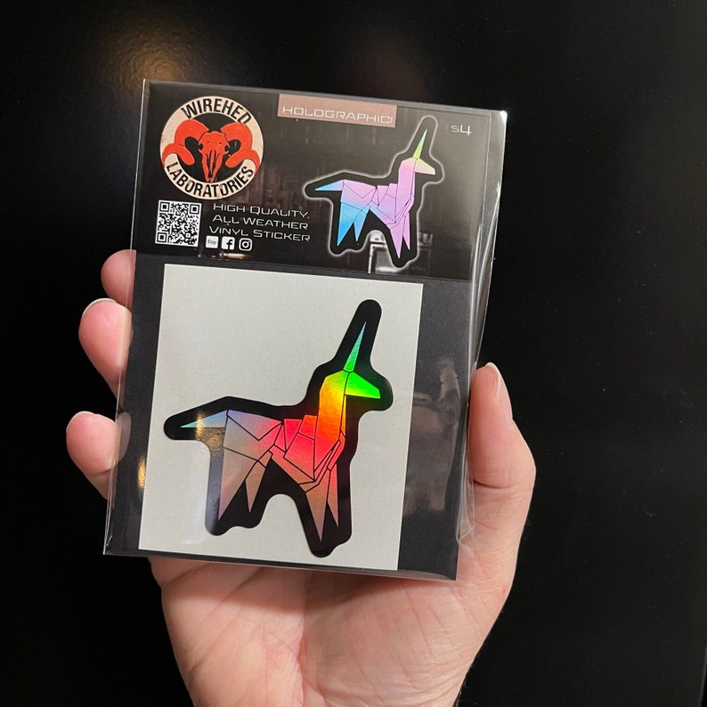 May include: A holographic sticker of a rainbow unicorn with the text "Wired Laboratories" and "Holographic" on a black background.