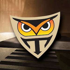 May include: A stylized owl with orange, yellow, and black colors, with a black T in the center of a beige shield shape.