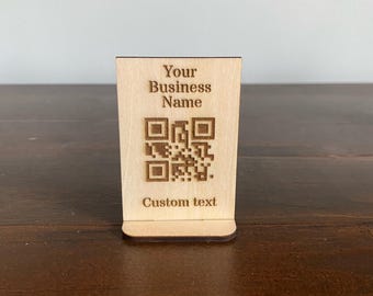 May include: A wooden sign with a QR code and the text "Your Business Name" and "Custom text".
