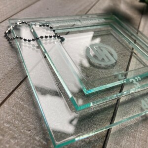 May include: Three clear glass squares with rounded edges, stacked on top of each other. The squares are labeled with the measurements 4", 3", and 2".