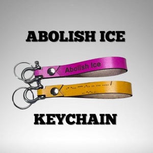 May include: Two leather keychains, one magenta and one yellow, with silver hardware. The magenta keychain reads "Abolish Ice" and the yellow keychain has a pattern of dots. The word "KEYCHAIN" is displayed below.