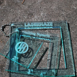 May include: Set of four clear blue acrylic quilting squares with measurements of 2", 3", and 4". The squares are labeled "LaserHaze Quilting Squares".