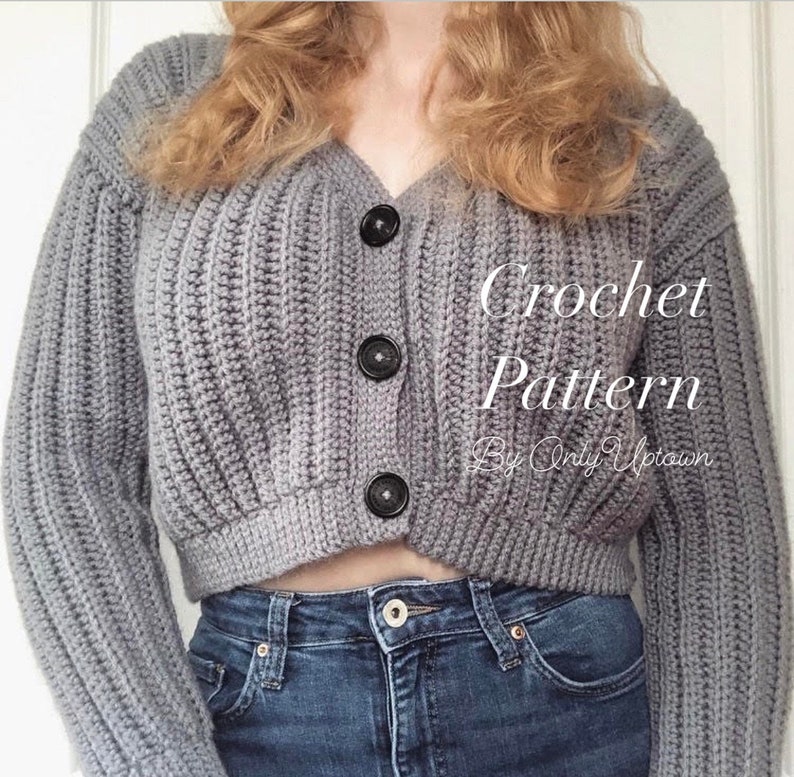 May include: A gray crochet cardigan with a v-neck and button closure. The cardigan is cropped and has a ribbed texture. The text "Crochet Pattern By Only Uptown" is visible on the image.