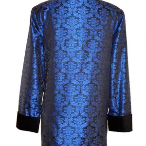 May include: A blue and black patterned jacket with a black velvet collar and cuffs.