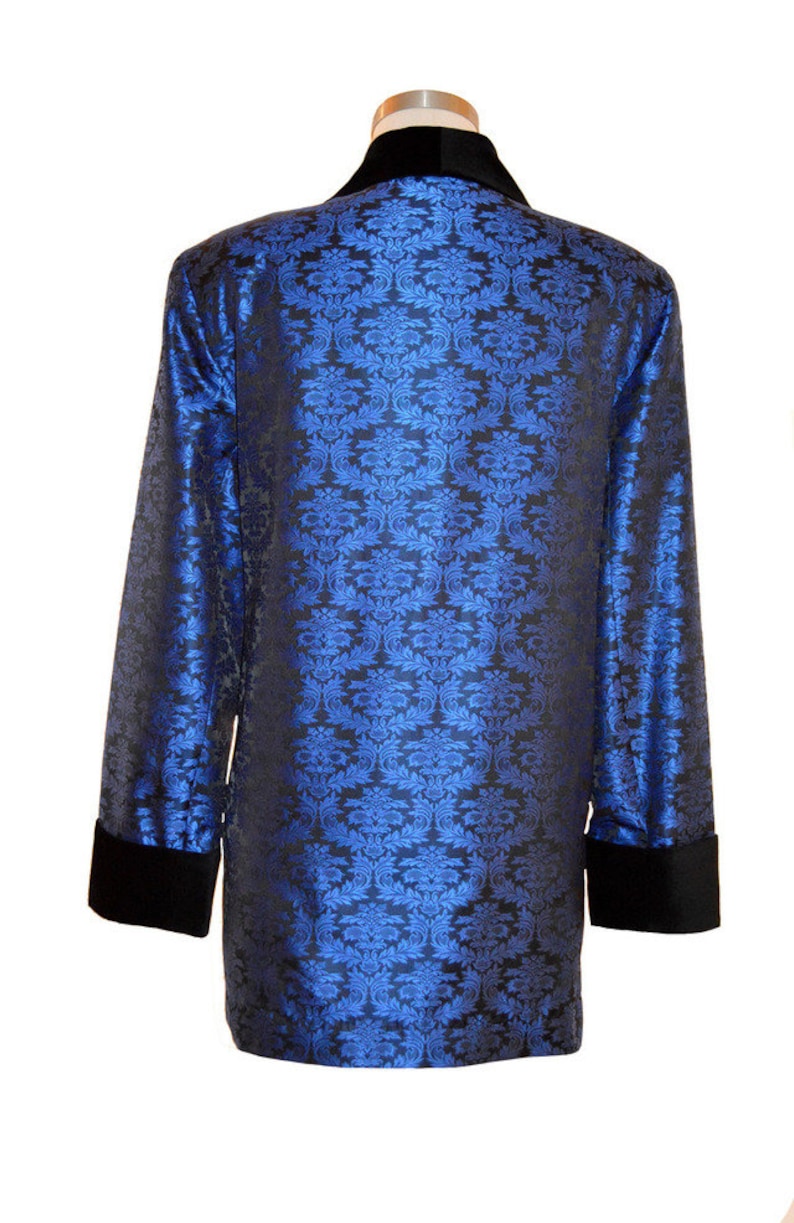 May include: A blue and black patterned jacket with a black velvet collar and cuffs.