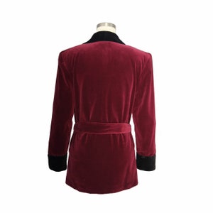May include: A burgundy velvet robe with a black velvet collar and cuffs. The robe has a self-tie belt.