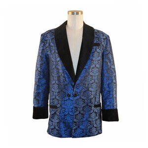 May include: A blue and black patterned blazer with a black velvet collar and cuffs. The blazer has a single button closure.