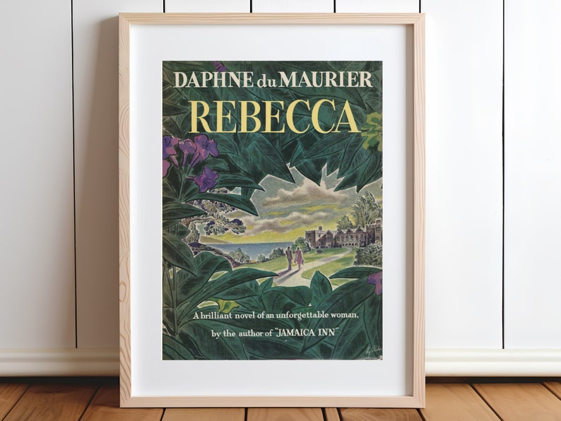 May include: A vintage book cover for the novel "Rebecca" by Daphne du Maurier. The cover features a lush green landscape with a glimpse of a large house in the distance. The title "Rebecca" is in yellow lettering.