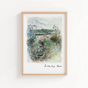 May include: A framed watercolour print depicting a rural scene with rabbits. The artwork shows a field with tall grass and a cloudy sky. The print is in a light wood frame and has the words "Watership Down" written in cursive.