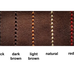 May include: Close-up of five leather swatches with different coloured stitching. The stitching colours are black, dark brown, light brown, natural, and red.
