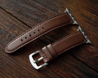 Dark brown leather padded Apple Watch strap.