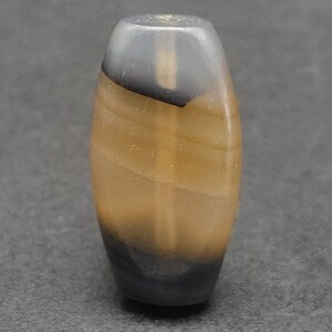May include: A brown and black agate bead with a swirling pattern. The bead is oval shaped and has a smooth, polished surface.