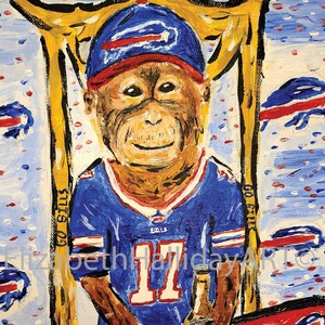 May include: A painting of a monkey wearing a blue and red football jersey with the number 17 on it. The monkey is holding a bottle of beer and is sitting at a table with two pizzas. The background is blue with white dots and the text "Go Bills" is written on the wall.