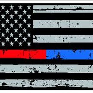 May include: A black and white American flag with a red stripe and a blue stripe across the bottom. The flag is distressed and has a faded look.