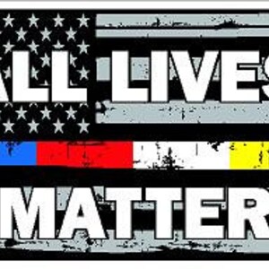 May include: A black and gray American flag with a thin blue, red, and yellow stripe across the bottom. The text "ALL LIVES MATTER" is printed in white across the flag.