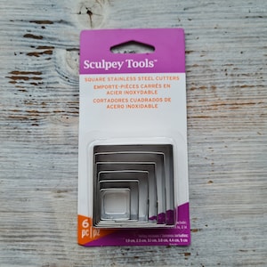May include: A package of six square stainless steel cutters, labeled "Sculpey Tools" in purple and orange text. The cutters are nested inside each other and range in size from 1.9 to 5 inches.