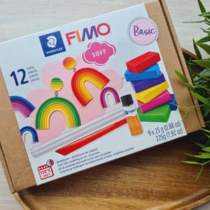 May include: A FIMO Soft modelling clay set with various colours, including red, blue, yellow, and green. The box also contains accessories and instructions. The package includes 9 x 25g (0.88 oz) of clay.