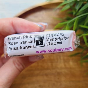 May include: A package of French Pink polymer clay. The label includes the text "French Pink", "Rose fran&ccedil;ais", and "Rosa franc&eacute;s". It also shows baking instructions: 275&deg;F (130&deg;C) for 30 minutes, and 1/4 in (6 mm). The website www.sculpey.com is also visible.
