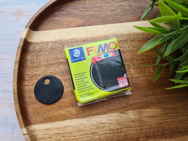 May include: A pack of black FIMO Kids modelling clay. The pack is yellow and black with the text "FIMO Kids" and "110&deg;C (230&deg;F)".