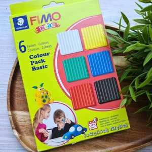 May include: A box of FIMO Kids modelling clay with six colours: white, yellow, green, blue, red, and black. The box includes 6 x 42 g (1.5 oz) of clay, totalling 252 g (9 oz).