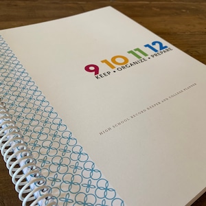 May include: A white spiral bound notebook with a blue and white patterned spine. The cover has the text "9 10 11 12 KEEP ORGANIZE PREPARE" in colorful text. The text "HIGH SCHOOL RECORD KEEPER AND COLLEGE PLANNER" is printed below the colorful text.