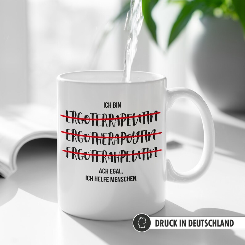 May include: White ceramic mug with black text that reads "ICH BIN" with three lines of text crossed out that read "ERGOFERRAPELATIVT", "ERGOTHERAPOYTAH", and "ERGOFERAMPELATINA". The text below the crossed out lines reads "ACH EGAL, ICH HELFE MENSCHEN."