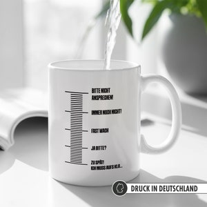 May include: White ceramic mug with a black scale and text that reads "Bitte nicht ansprechen! Immer noch nicht! Fast wach Ja bitte? Zu sp&auml;t! Ich muss aufs Klo..."  Printed in Germany.