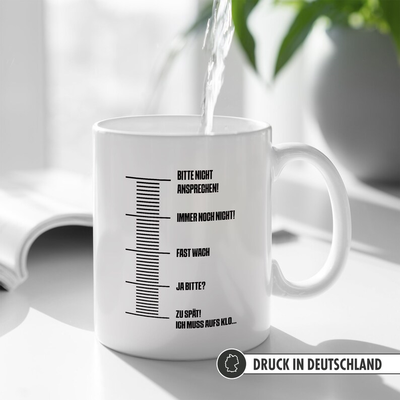 May include: White ceramic mug with a black scale and text that reads "Bitte nicht ansprechen! Immer noch nicht! Fast wach Ja bitte? Zu sp&auml;t! Ich muss aufs Klo..."  Printed in Germany.