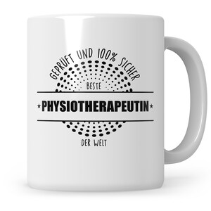 May include: White ceramic mug with black text that reads "Geprüft und 100% sicher beste Physiotherapeutin der Welt" in a circle with black dots.