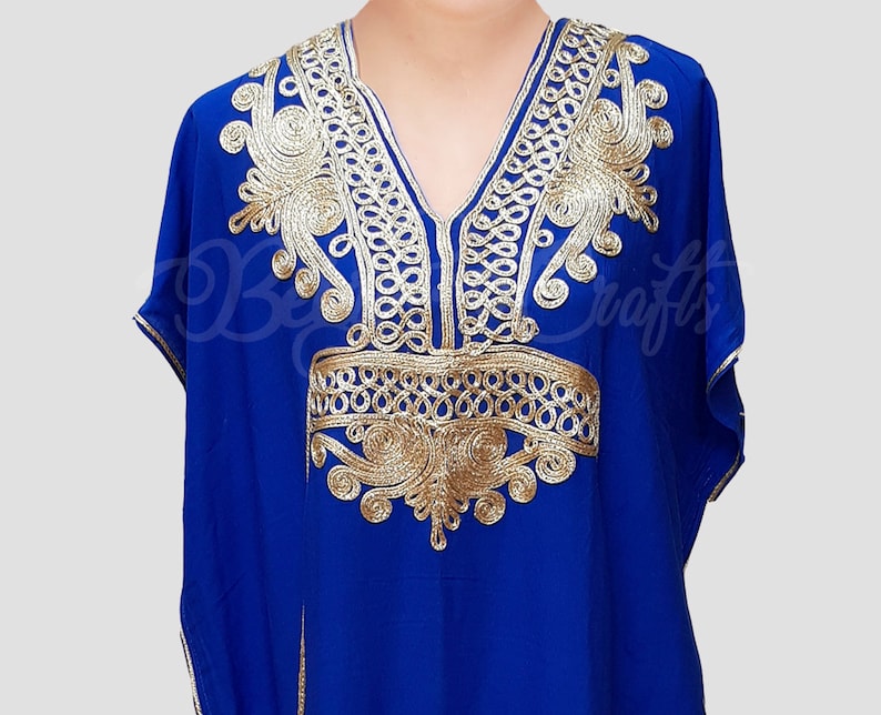 May include: A royal blue kaftan with gold embroidery. The embroidery features a floral design with intricate details.