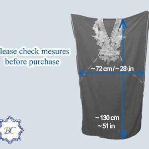 May include: A black, long-sleeved tunic with silver embroidery around the neckline. The tunic measures approximately 51 inches long and 28 inches wide.