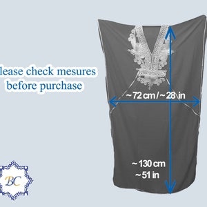 May include: A black, long-sleeved, loose-fitting garment with silver embroidery around the neckline. The garment measures approximately 51 inches long and 28 inches wide.