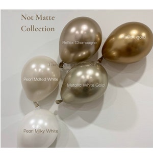 May include: Five latex balloons in different colours and finishes. The balloons are: Pearl Malted White, Pearl Milky White, Metallic White Gold, Reflex Champagne, and Reflex Gold.