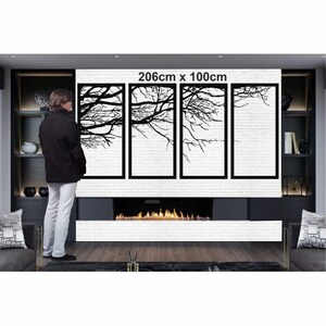 May include: A black metal wall art sculpture featuring four panels with a silhouette of tree branches. The sculpture is 206cm x 100cm and is displayed above a fireplace in a modern living room.