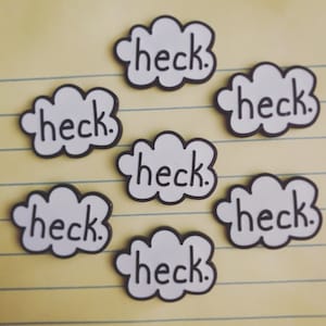 May include: Six white cloud-shaped pins with black outlines and the word "heck." written in black inside each cloud.