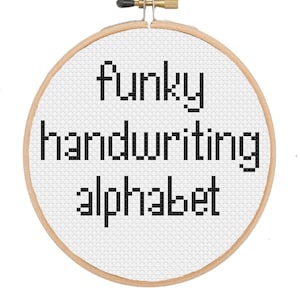 May include: A white embroidery hoop with the text "Funky handwriting alphabet" in black.